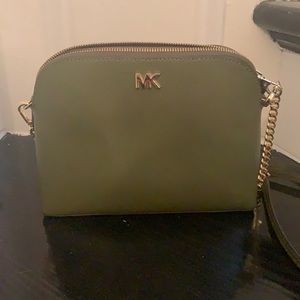 Small MK olive green crossbody bag with gold chain strap detail.